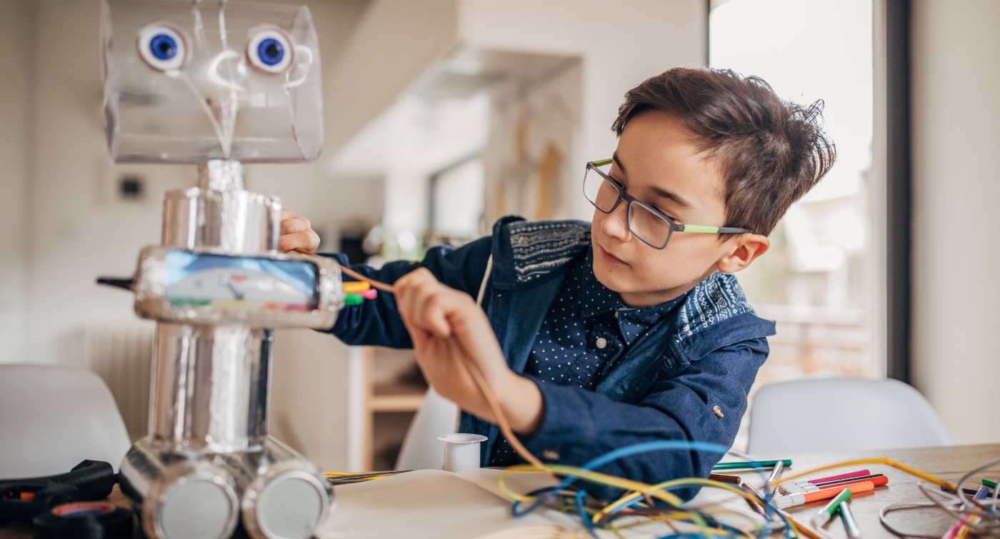 Boy Playing with Recycled Robot
